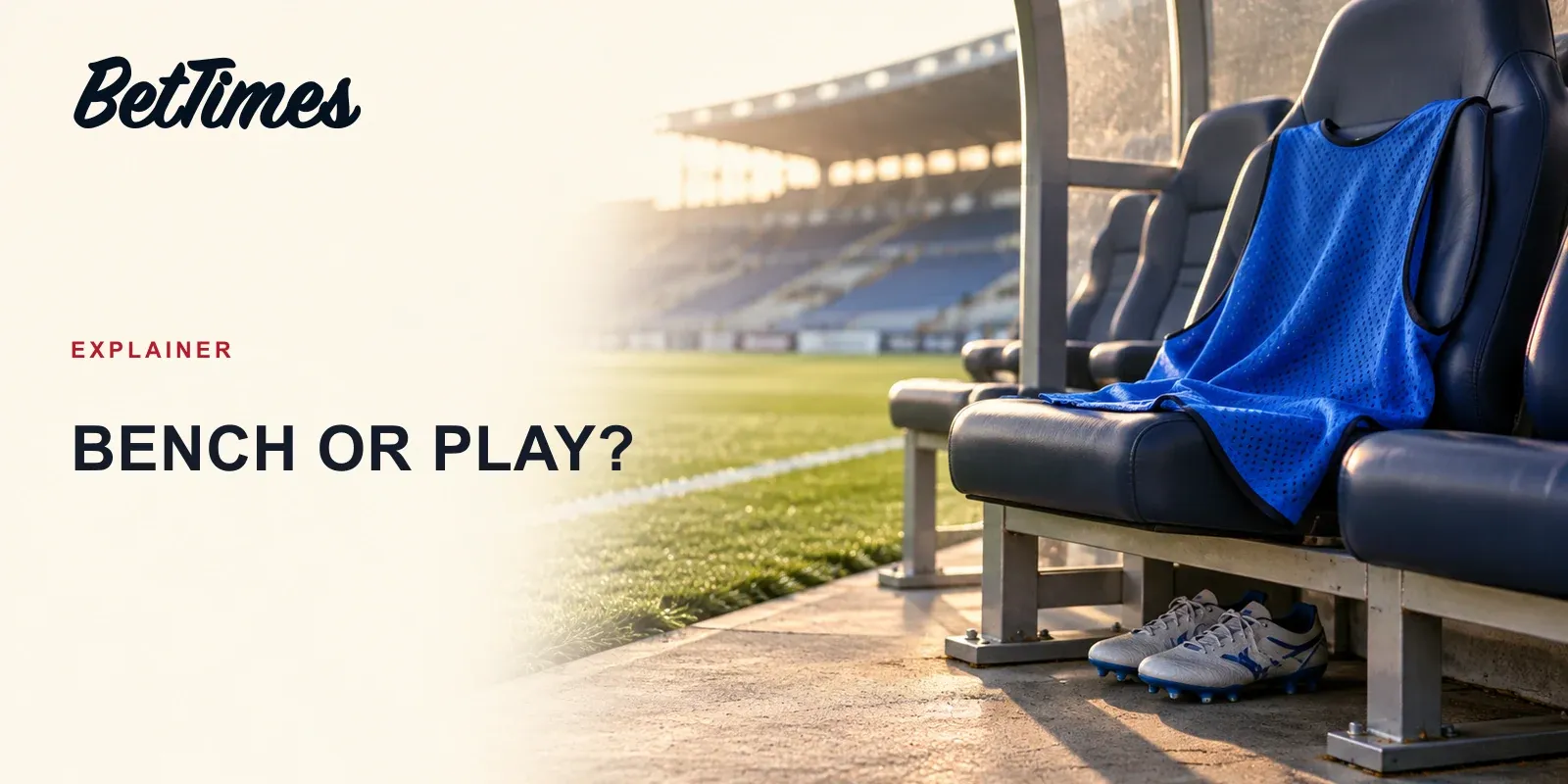 An unbranded substitute's training bib rests on a football dugout seat beside the touchline, illustrating selection versus actual participation.